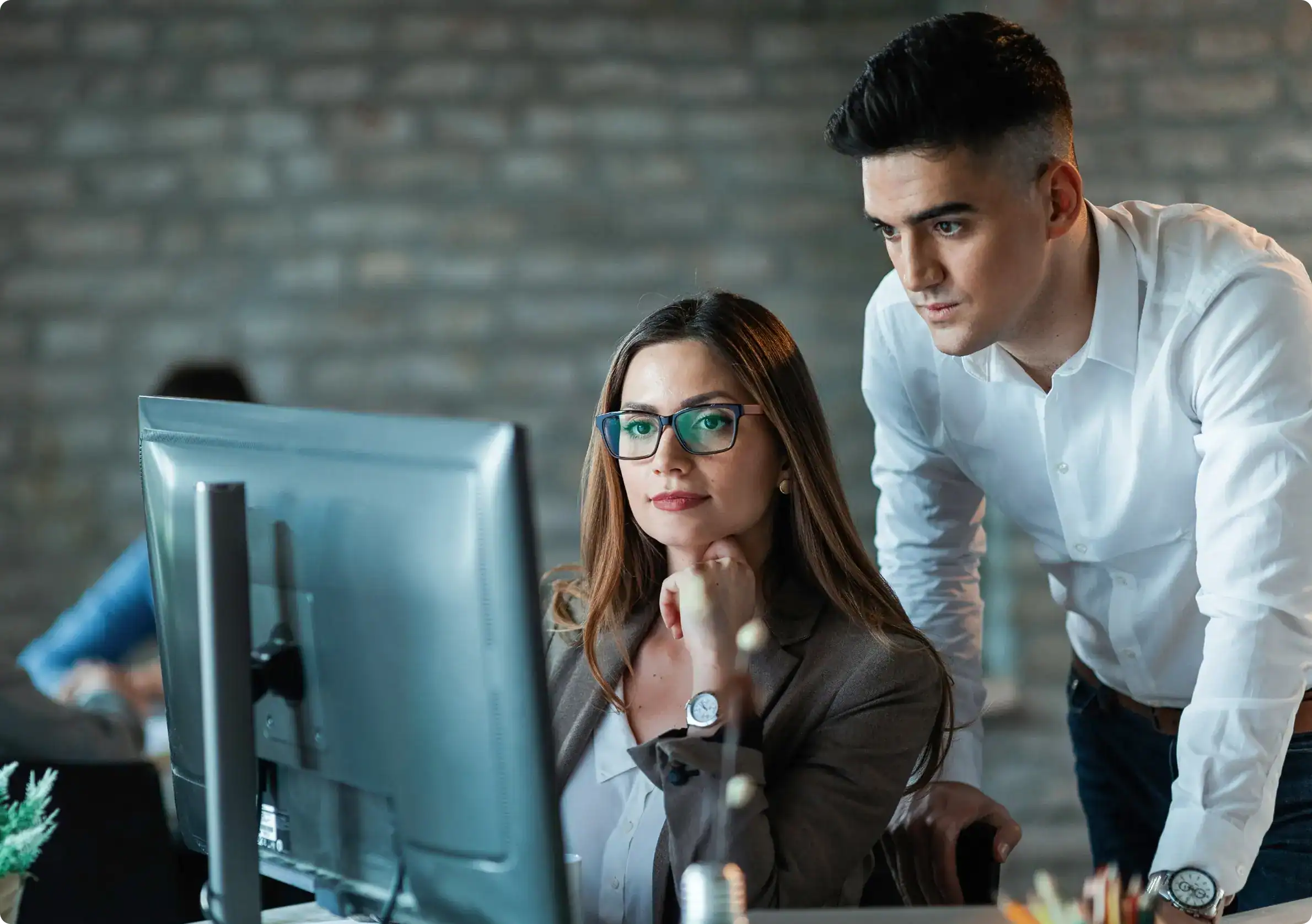 IT professionals discussing Incident Response Services at workstation