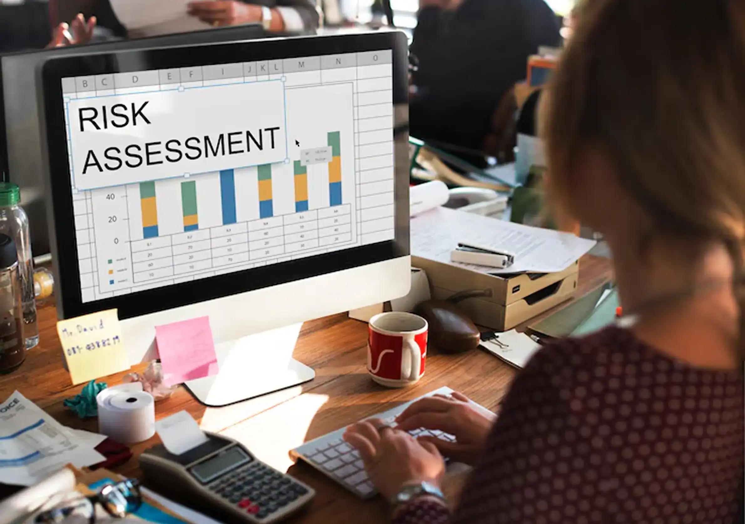 Team analyzing threat data on dual monitors during a security awareness training session, focusing on cyber security awareness and human risk management in a modern workplace setting.