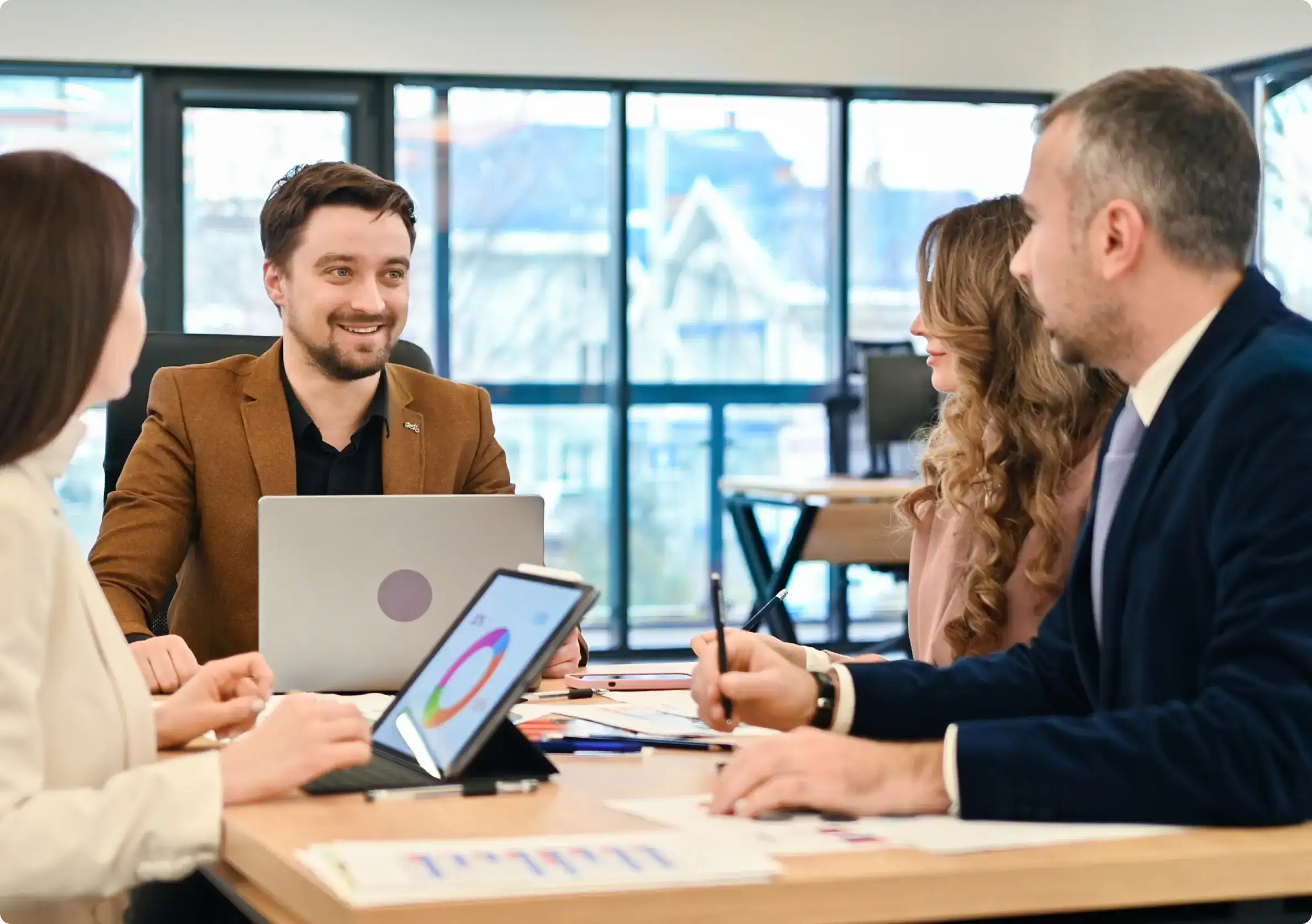 IT consultants discussing enterprise identity strategy using Saviynt IAM solutions for streamlined access, compliance, and governance.